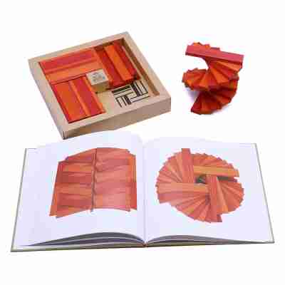 Livre de modèles ouvert avec planchettes Kapla orange et rouge et coffret