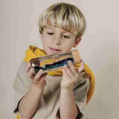 Enfant observant une bouteille sensorielle Petit Prince allongée